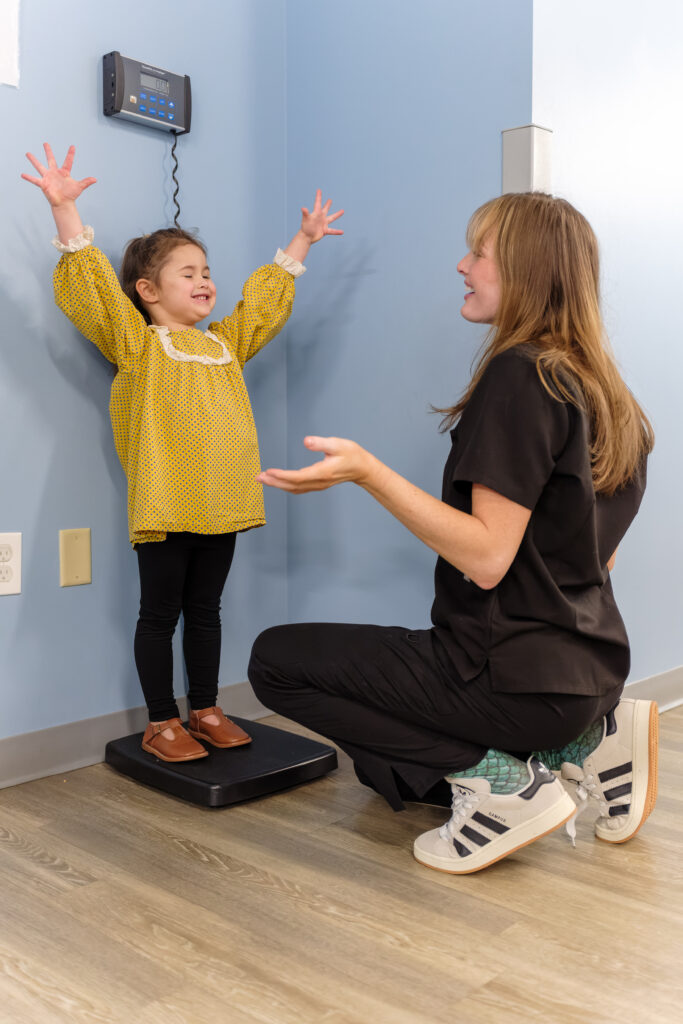Toddler weigh in at pediatric wellness exam