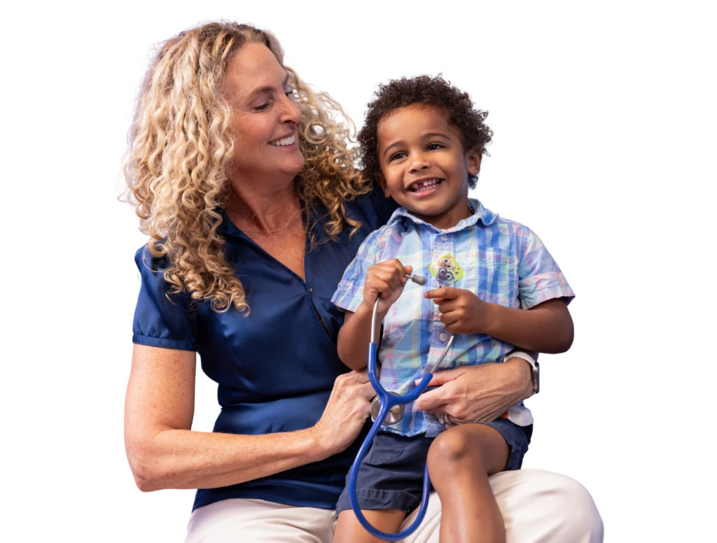 Colleen Boylston founding physician with pediatric patient