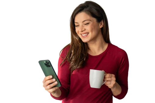 Brunette woman sips coffee looks at resources on phone